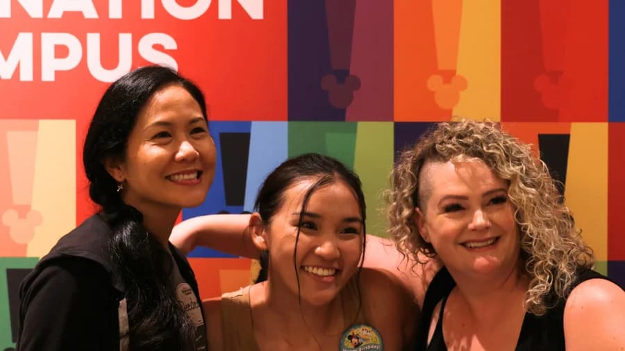 Mouseketeers Deedee Magno Hall and Jennifer McGill with a student at Disney's Imagination Campus